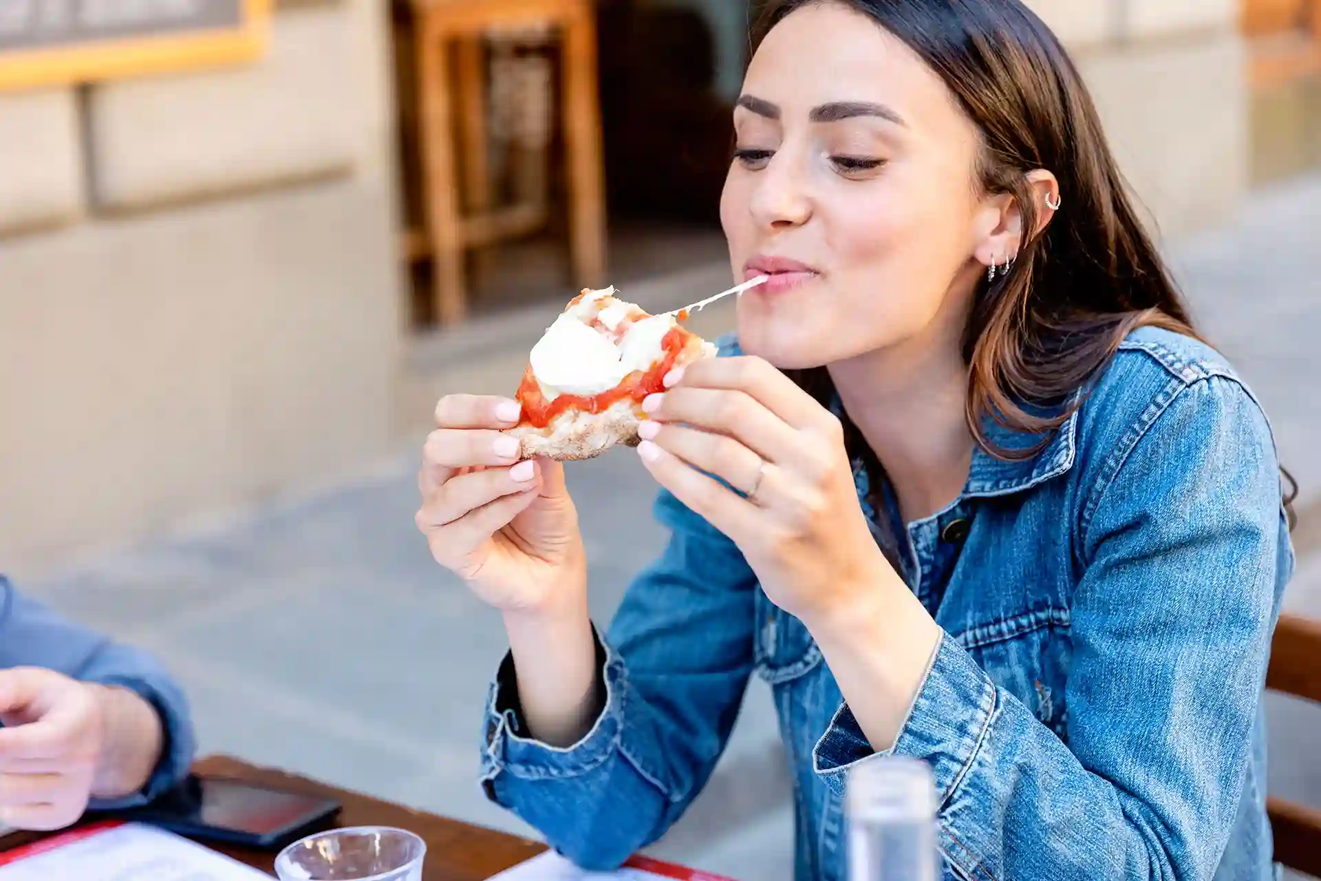 woman eating pizza